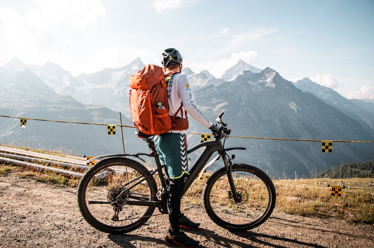 Fahrradfahrer vor Panorama mit Bergen in der Schweiz.